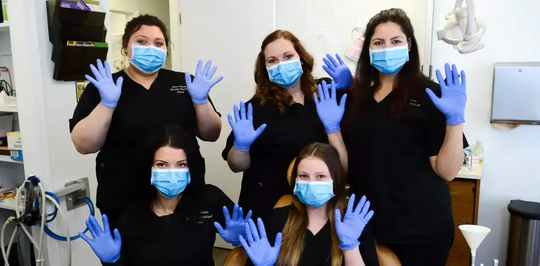 {{ school.name }} students posing for a group photo with gloves and masks on in dental office {{ school.name }} students posing for a group photo with gloves and masks on in dental office