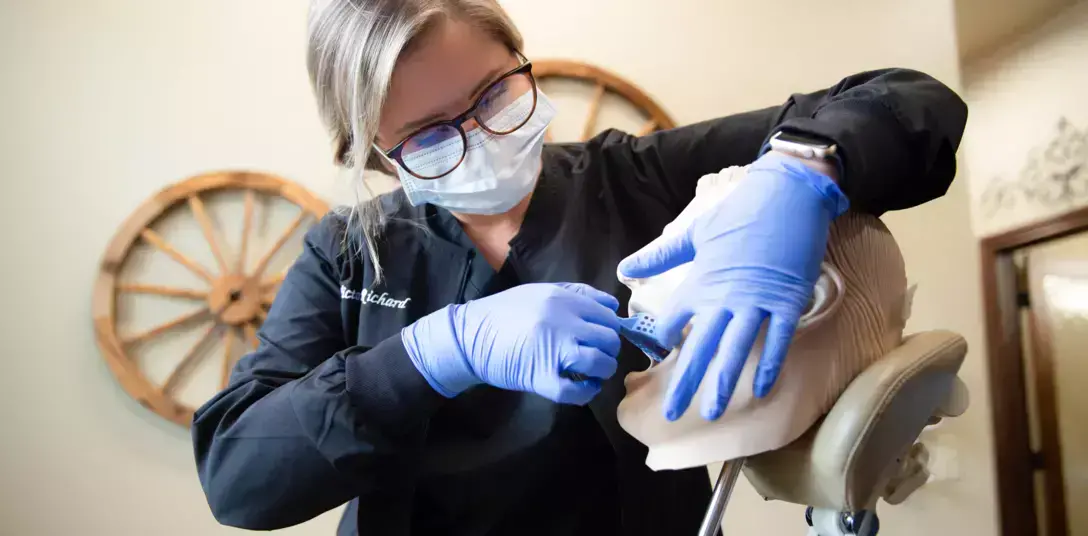 {{ school.name }} instructor demonstrating a dental examination {{ school.name }} instructor demonstrating a dental examination