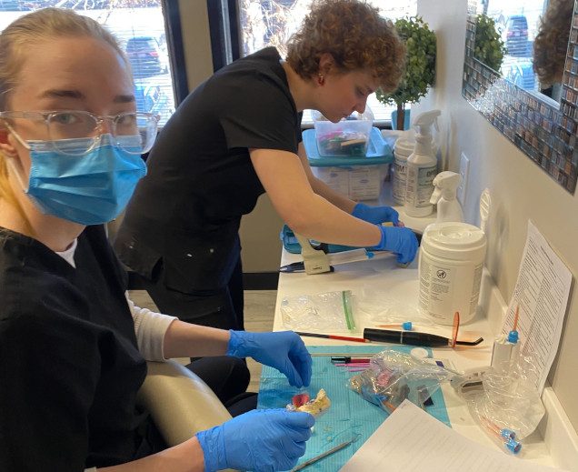 {{ school.name }} students creating dental molds in the lab {{ school.name }} students creating dental molds in the lab