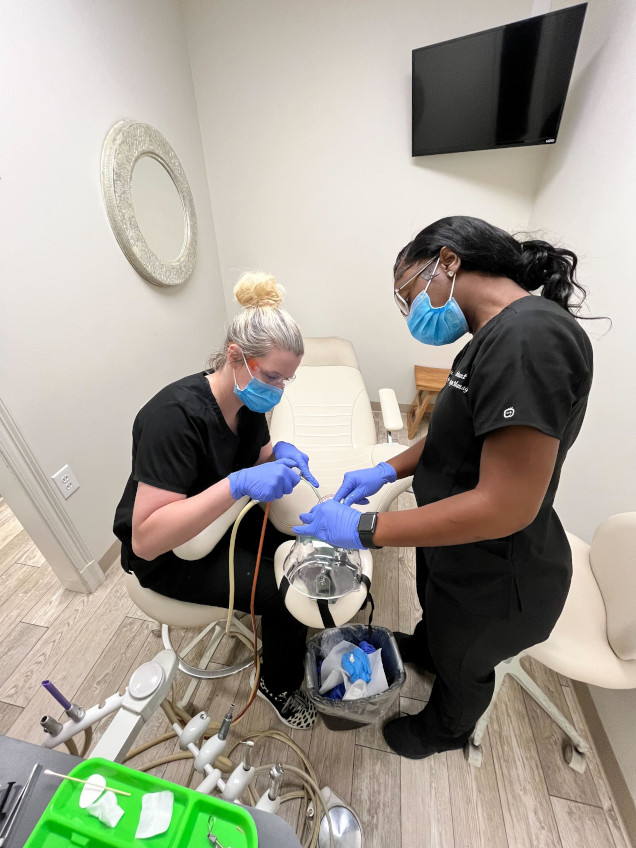 {{ school.name }} student working with their instructor on dental procedures {{ school.name }} student working with their instructor on dental procedures