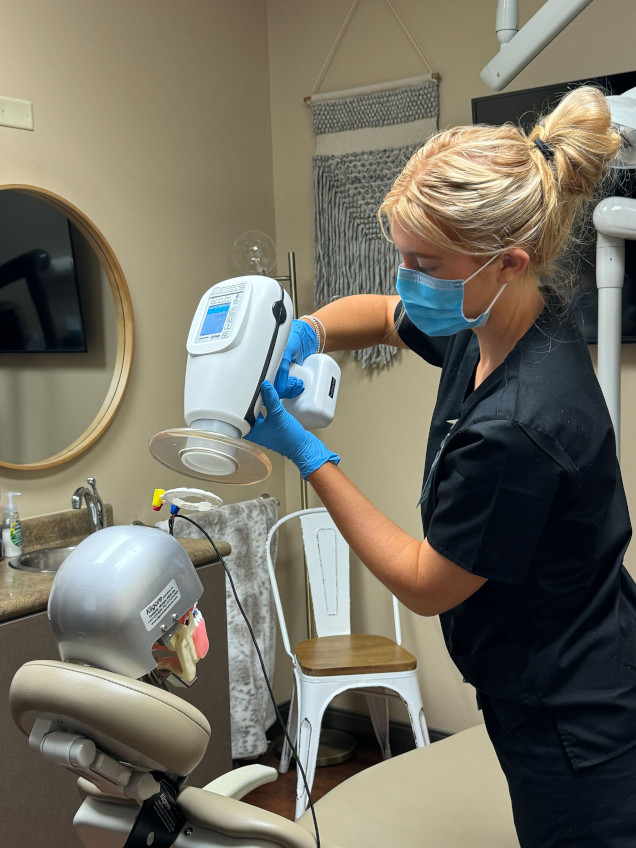 {{ school.name }} student training to take dental x-rays {{ school.name }} student training to take dental x-rays