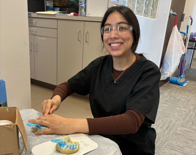 {{ school.name }} student creating a dental mold in class {{ school.name }} student creating a dental mold in class