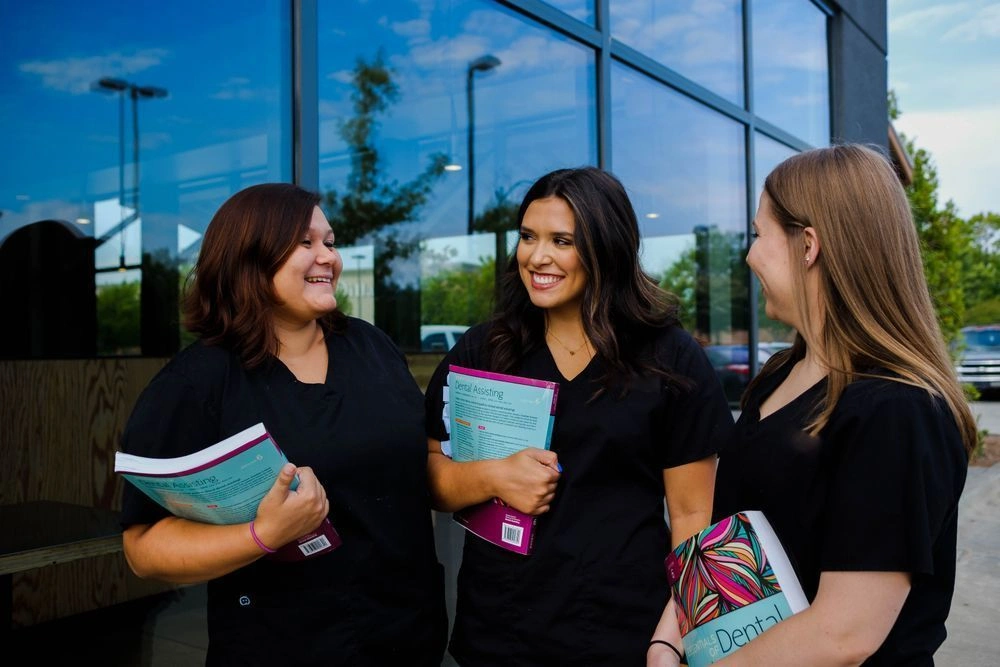 {{ school.name }} students outside of facility with their workbooks in hand {{ school.name }} students outside of facility with their workbooks in hand